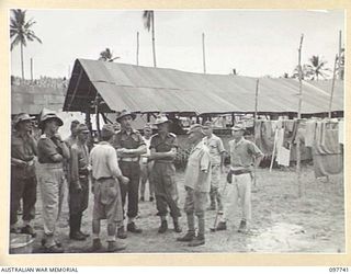 MUSCHU ISLAND, NEW GUINEA. 1945-10-10. MAJOR E.S. OWENS, ASSISTANT ADJUTANT AND QUARTERMASTER GENERAL, HEADQUARTERS 6 DIVISION, SPEAKING TO JAPANESE MEDICAL OFFICERS AND LIEUTENANT GENERAL K. ..