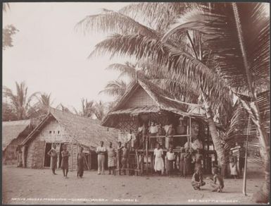 Villagers gathered outside a house in Maravovo village, Guadalcanar, Solomon Islands, 1906 / J.W. Beattie