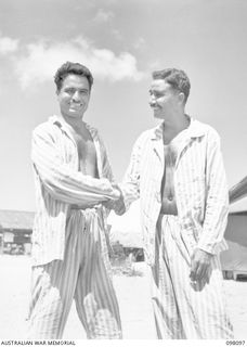 BORAM BEACH, NEW GUINEA. 1945-10-17. JEMADAR (LT) CHINT SINGH, 2/12TH F.F. REGIMENT (1) SHAKES HANDS WITH JEMADAR (LT) ABDOL LATIF, 4/9 JATS REGIMENT, OUTSIDE A HOSPITAL WARD, 2/15 FIELD AMBULANCE. ..