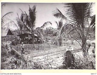 SWAN BEACH, JACQUINOT BAY. NEW BRITAIN. 1944-12-10. 2 FIELD AMBULANCE, AUSTRALIAN ARMY MEDICAL CORPS TROOPS FROM A VICTORIAN UNIT, WITHIN THEIR CAMP AREA NEAR THE WUNUNG RIVER. PRINCES BRIDGE, A ..