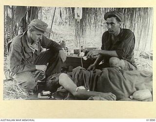 1942-12-05. BUNA. A MEDICAL OPERATION IS PERFORMED AT AN ADVANCED AMERICAN DRESSING STATION ONLY A FEW HUNDRED YARDS FROM THE FRONT LINE. THIS OPERATION SAVED THE LIFE OF A MAN WHO COULD NOT HAVE ..