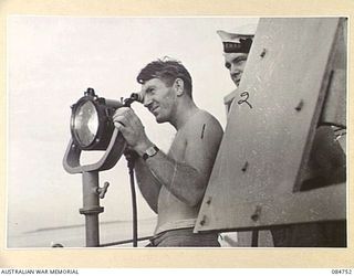 MIOS WUNDI, DUTCH NEW GUINEA. 1944-11-12. A SIGNALLER OPERATING FROM THE BRIDGE OF HMAS STAWELL FOLLOWING ENTRY INTO HARBOUR