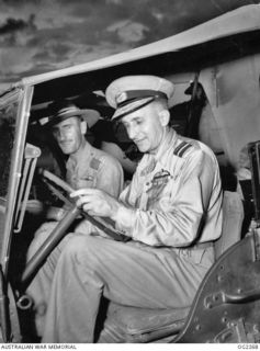 TOROKINA, BOUGAINVILLE ISLAND, SOLOMON ISLANDS. 1945-02-18. THE CHIEF OF AIR STAFF AIR VICE-MARSHAL JONES CB CBE DFC DRIVING A JEEP DURING HIS TOUR OF INSPECTION OF RAAF UNITS AT TOROKINA. WITH HIM ..