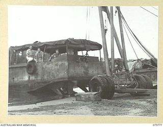 LABU, NEW GUINEA. 1944-12. THE ARMY VESSEL AB 394 BEING BEACHED AT THE 1ST WATERCRAFT WORKSHOP SECTION, AUSTRALIAN ELECTRICAL AND MECHANICAL ENGINEERS WITH THE ASSISTANCE OF A MOBILE CRANE AND ..