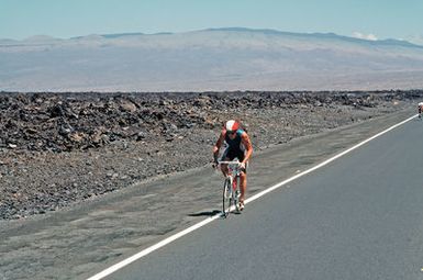 Major (MAJ) Gary Castelli, a member of the US Air Force, bikes downhill during the 112-mile bicycle race, part of the 1987 Ironman Competition