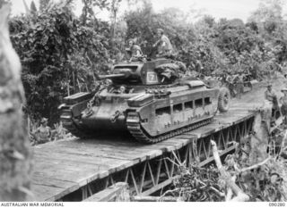 BOUGAINVILLE. 1945-03-30. A MATILDA TANK OF B SQUADRON, 2/4TH ARMOURED REGIMENT, CROSSING THE 24 TON BOX GIRDER BRIDGE REPLACED BY ENGINEERS OF 15TH FIELD COMPANY, ROYAL AUSTRALIAN ENGINEERS, IN ..