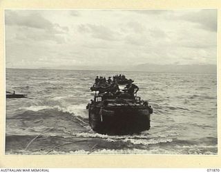 LAE, NEW GUINEA. 1944-03-30. DUKWS (LANDING CRAFT MECHANIZED), OF AMPHIBIOUS PLATOON, 151ST GENERAL TRANSPORT COMPANY, RETURNING FROM THEIR DAILY TASKS OF UNLOADING SHIPS MOORED OFF SHORE