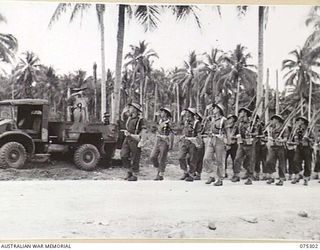 MADANG, NEW GUINEA. 1944-08-15. VX27 MAJOR GENERAL A.H. RAMSAY, CBE, DSO, ED, GENERAL OFFICER COMMANDING 5TH DIVISION (9), TAKING THE SALUTE FROM MEMBERS OF THE 22ND INFANTRY BATTALION DURING THE ..