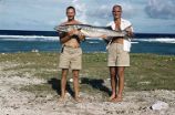 Scientists displaying fish, Rongelap Island, summer 1964