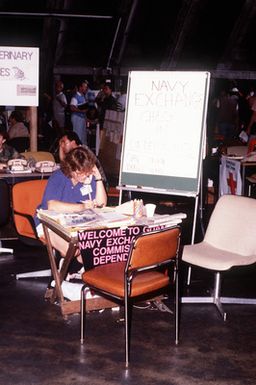 A woman talks on the Navy commissary telephone help line to get assistance for military and civilian personnel arriving from the Philippine Islands after the June 10 eruption of Mount Pinatubo deposited more than four inches of volcanic ash on the area, disrupting base operations. More than 20,000 evacuees have been removed from the area as a part of the U.S. military's Operation Fiery Vigil