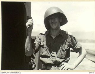 PURIATA RIVER AREA, BOUGAINVILLE ISLAND. 1944-12-31 SX23588 SECOND LIEUTENANT THOMAS HENRY FARRELL, PUBLIC RELATIONS OFFICER, HEADQUARTERS 2ND AUSTRALIAN CORPS, WEARING A SPECIAL AMERICAN STEEL ..