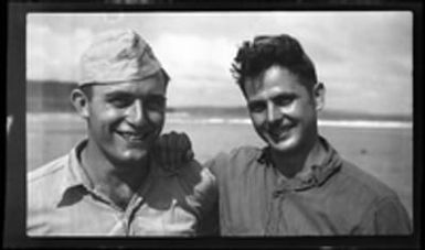 [Servicemen Elmer A. Ball and Gruber on beach]