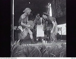 ALEXISHAFEN, NEW GUINEA. 1944-07. A SCENE DURING THE ENTERTAINMENT "PISTOL PACKING MOMMA" STAGED DURING A CONCERT AT NORTH ALEXISHAFEN BY MEMBERS OF HEADQUARTERS 8TH INFANTRY BRIGADE. LEFT TO ..
