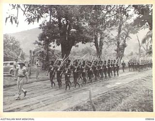 RABAUL, NEW BRITAIN. 1945-10-11. THE FIRST PLATOON OF THE ROYAL PAPUAN CONSTABULARY, MARCHING PAST THE SALUTING BASE. THE SALUTE WAS TAKEN BY MAJOR GENERAL K.W. EATHER, GENERAL OFFICER COMMANDING ..