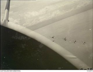 IN FLIGHT OVER BOUGAINVILLE ISLAND, SOLOMON ISLANDS. 1945-01-17. PHOTOGRAPH TAKEN FROM A WIRRAWAY AIRCRAFT OF NO. 5 (ARMY CO-OPERATION) SQUADRON RAAF WHICH ALSO ACT AS PATHFINDERS TO ROYAL NEW ..