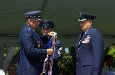 The CHIEF of STAFF United States Air Force (CSAF) General (GEN) John P. Jumper, presents the Headquarters Pacific Air Forces (PACAF) with the Air Force Organizational Excellent Award during GEN William J. Begert's Change of Command and Retirement Ceremony at Hickam Air Force Base (AFB), Hawaii (HI)