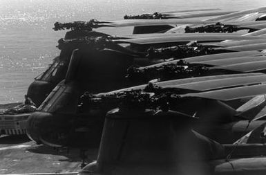 A left side view of several CH-46 Sea Knight helicopters parked on the flight deck of the amphibious assault ship USS GUAM (LPH 9), during operations off the coast of Beirut, Lebanon