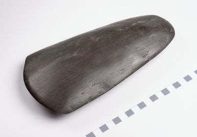 Large, dark-brown / green polished, stone axehead. Possibly a serpentine axe.