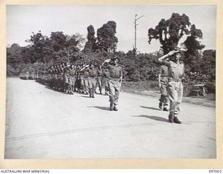 TOROKINA, BOUGAINVILLE. 1945-09-24. LIEUTENANT COLONEL W.M. MAYBERRY, COMMANDING OFFICER 58/59 INFANTRY BATTALION, 15 INFANTRY BRIGADE, SALUTING AS HE LEADS HIS MEN PAST THE SALUTING BASE IN THE ..