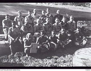 LAE, NEW GUINEA. 1945-12. GROUP PORTRAIT OF PERSONNEL OF 4 ADVANCED ORDNANCE DEPOT