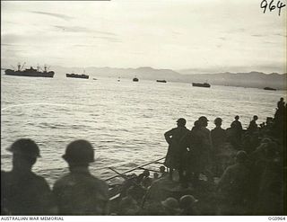 AITAPE AREA, NORTH EAST NEW GUINEA. 1944-04-22. US AND RAAF TROOPS WATCH FROM THE DECK OF A LANDING SHIP, TANK (LST) THE ALLIED CONVOY COMING IN FOR THE LANDING AT KAROKO VILLAGE NEAR AITAPE