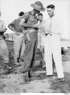 MALAGUNA, NEW BRITAIN. 1945-09-20. MR. R. DIERCKE, A NEW IRELAND CIVILIAN (1), BEING INTERVIEWED BY WAR CORRESPONDENT MR. R. JOHNSTON (2), AFTER HIS RELEASE FROM NEW IRELAND FOLLOWING THE JAPANESE ..