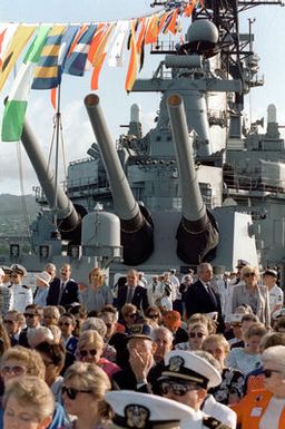Guests aboard the battleship USS MISSOURI (BB-63) listen to a speech by President George Bush. The president is speaking from the USS Arizona Memorial as part of the observance of the 50th anniversary of the Japanese attack on Pearl Harbor