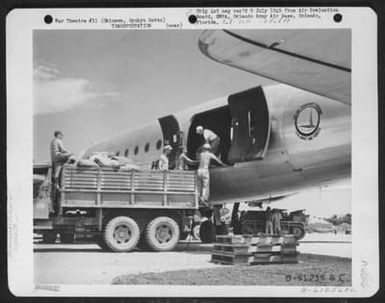 Mail Being Unloaded From A Douglas C-54 'Skymaster'. This Mail Is Coming From Guam, A 6 Hour Flight, And Will Take Wounded Patients Back On The Return Trip. Yontan Airstrip, Okinawa, Ryukyu Retto. 27 July 1945. (U.S. Air Force Number B61256AC)