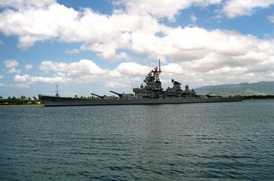 Crew members man the rails aboard the battleship USS MISSOURI (BB-63) as the ship departs from the naval station after a visit. The MISSOURI is returning to its home port of Naval Station, Long Beach, Calif., after serving in the Persian Gulf region during Operation Desert Shield and Operation Desert Storm.