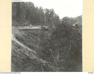 REINHOLD HIGHWAY, NEW GUINEA, 1944-02-25. A ROAD SHELF ABOUT 20 MILES FROM WAU, LOOKING BACK TOWARDS WAU