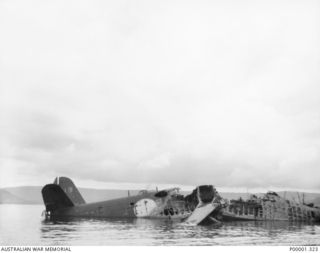 NEW BRITAIN, 1945-09. WRECKAGE OF A JAPANESE KAWANISHI H8K "EMILY" FLYING BOAT LYING IN SHALLOW WATER IN THE RABAUL/GAZELLE PENINSULA AREA. (RNZAF OFFICIAL PHOTOGRAPH.)