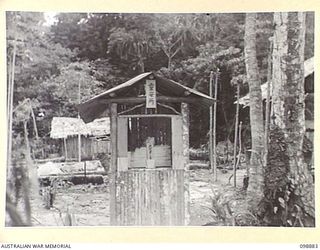 PIEDU ISLAND, SOLOMON ISLANDS. 1945-11-13. SHRINE OF THE DEAD IN JAPANESE AREA 10. THE TOP NOTICE TRANSLATES "PLACE TO KEEP ASHES OF THE DEAD" AND THE LOWER INSCRIPTION READS "PLACE FOR SOULS OF ..