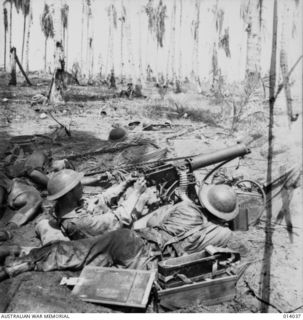 BUNA, PAPUA. 1943-01-01. FIGHTING DURING THE FINAL ASSAULT ON BUNA. AUSTRALIAN MACHINE GUNNERS IN ACTION AROUND 5.30 PM NEW YEARS DAY. DEAD MAN ON LEFT WAS CORPORAL CHARLES KNIGHT. PRIVATE JOHN ..