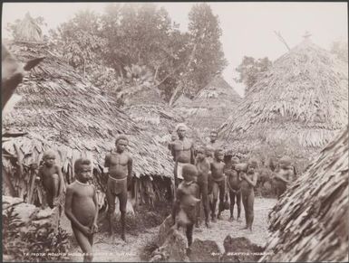 Men and children among round houses of Te Motu, Santa Cruz Islands, 1906 / J.W. Beattie