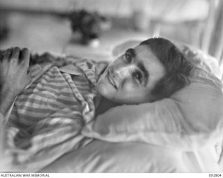 LAE, NEW GUINEA. 1945-06-09. PRIVATE F. MCLENNAN, 24 INFANTRY BATTALION, A PATIENT AT 2/7 GENERAL HOSPITAL. SHOT BY A JAPANESE SNIPER WHEN HIS PATROL WAS AMBUSHED, HE WAS LEFT FOR DEAD IN THE ..