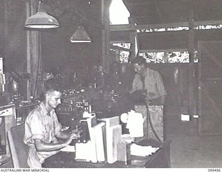 TOROKINA, BOUGAINVILLE, 1945-12-05. LANCE-SERGEANT (L-SGT) B. J. STEPHEN (1), L-SGT J. C. ELLIOT (2) AND WARRANT OFFICER 1 W. A. NEW (3), WORKING ON MACHINES IN THE WORKSHOP AT 1 DETACHMENT MOBILE ..