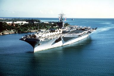 Aerial port bow view of the nuclear-powered aircraft carrier USS CARL VINSON (CVN 70) entering port