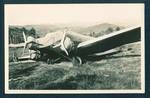 Aeroplane parked, front covered, engine in need of repair, [Bulolo Gold Dredging mine, Bulolo?], New Guinea, c1932 to 1933