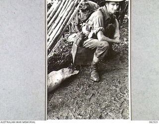 SHAGGY RIDGE, NEW GUINEA. 1943-12-27. NX150967 PRIVATE A. K. MORROW OF THE 2/16TH AUSTRALIAN INFANTRY BATTALION, 21ST AUSTRALIAN INFANTRY BRIGADE, RELAXING JUST BEFORE THE UNITS SUCCESSFUL ATTACK ..