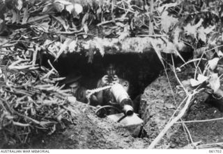 WAREO, NEW GUINEA. 1943-12-09. VX26054 SERGEANT C. GAUNT OF TRAFALGAR, VIC (LEFT); VX51267 CORPORAL J. R. BROWN OF BRUNSWICK, VIC (RIGHT); VICKERS MACHINE GUN CREW OF C COMPANY, 2/23RD AUSTRALIAN ..