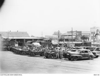 CAIRNS, QLD. 1944-10-18. TRANSPORT OF FIRST ARMY IN THE MARSHALLING YARD AT THE WHARF AWAITING EMBARKATION TO NEW GUINEA ABOARD THE LIBERTY SHIP SS JAMES OLIVER