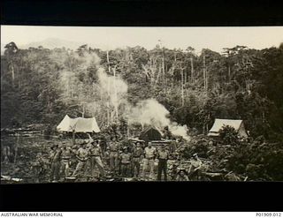 Milne Bay, New Guinea. 1943. Informal group portrait of 78th Anti-Aircraft Searchlight Battery members at the Anti-Aircraft station at Milne Bay. Second from the left is Major R. J. (Bob) Thomson, ..