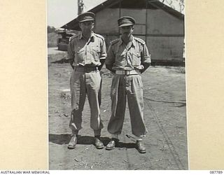 MAPEE AREA, QUEENSLAND. 1945-03-23. MAJOR W.L. SPEIGHT, (1), WITH CAPTAIN G. ATKIN, (2). THEY ARE ORIGINAL MEMBERS OF HEADQUARTERS 11 DIVISION AND SERVED AT MILNE BAY