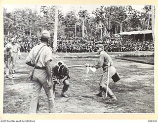 KARAVIA BAY, NEW BRITAIN. 1945-10-23. MAJOR GENERAL K.W. EATHER, GENERAL OFFICER COMMANDING 11 DIVISION, VISITED THE INDIAN EX-PRISONER OF WAR CAMP AT KARAVIA BAY. SHOWN, A SKETCH DEPICTING THE ..