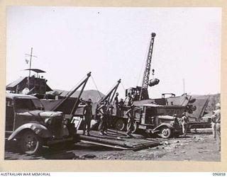 MALAGUNA, NEW BRITAIN. 1945-09-21. SCENE AT THE BEACHHEAD DURING UNLOADING OF SUPPLIES AND EQUIPMENT FOR DISTRIBUTION THROUGHOUT THE AREA. TROOPS OF HQ 11 DIVISION AND 4 INFANTRY BRIGADE NOW OCCUPY ..