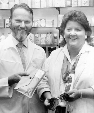 Christine Abbott wins a trip to Rarotonga; with Russell Schultz, owner of Gibbs Pharmacy.