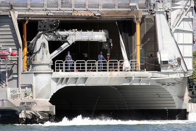 US Navy (USN) Sailors watch from the fantail on board the USN experimental High Speed Vehicle 2 (HSV 2) Swift as the vessel shifts berths at Pearl Harbor, Hawaii (HI). The Swift is taking part in the multi-national maritime Exercise RIM OF THE PACIFIC 2004 (RIMPAC). RIMPAC is the largest international maritime exercise in the waters around the Hawaiian Islands. This yearßs exercise includes seven participating nations: Australia, Canada, Chile, Japan, South Korea, United Kingdom and United States. RIMPAC is intended to enhance the tactical proficiency of participating units in a wide array of combined operations at sea, while enhancing stability in the Pacific Rim region