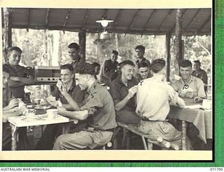 WAREO, PAPUA, NEW GUINEA, 1944-03-29. TROOPS AT B COMPANY, 4TH FIELD AMBULANCE REST CAMP RELAXING IN THE RED CROSS RECREATION HUT WHICH IS WELL SUPPLIED WITH AMUSEMENTS, A RADIO SET, AND GAMES. A ..