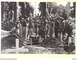 SORAKEN, BOUGAINVILLE, 1945-09-17. CHAPLAIN E.V. CONSTABLE CONDUCTING THE BURIAL SERVICE FOR SAPPER R.C. KENNON, KILLED IN ACTION ON BOUGAINVILLE. THE REMAINS WERE RECOVERED BY 42 PORT LANDING ..