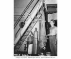 Arlis McCartner with seven foot shark caught from aboard the USS CHILTON, vicinity of Bikini Atoll, summer 1947